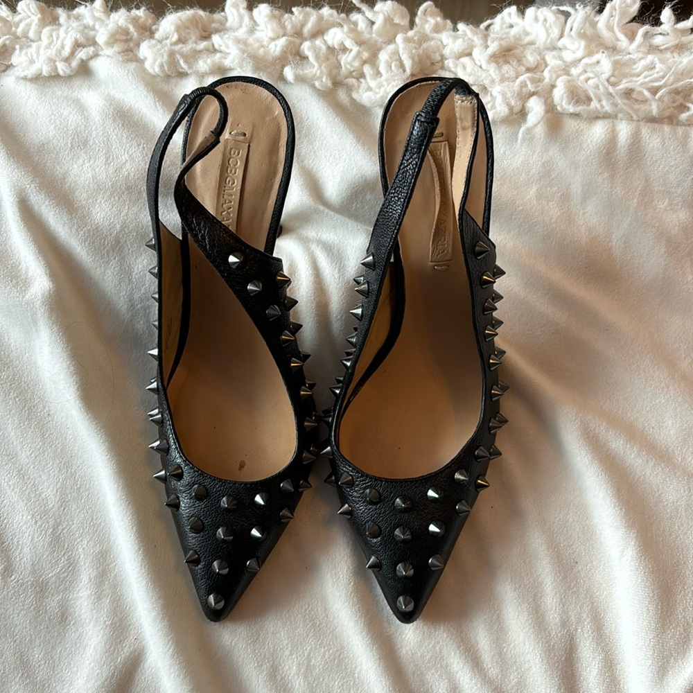 Black leather spiked heels.